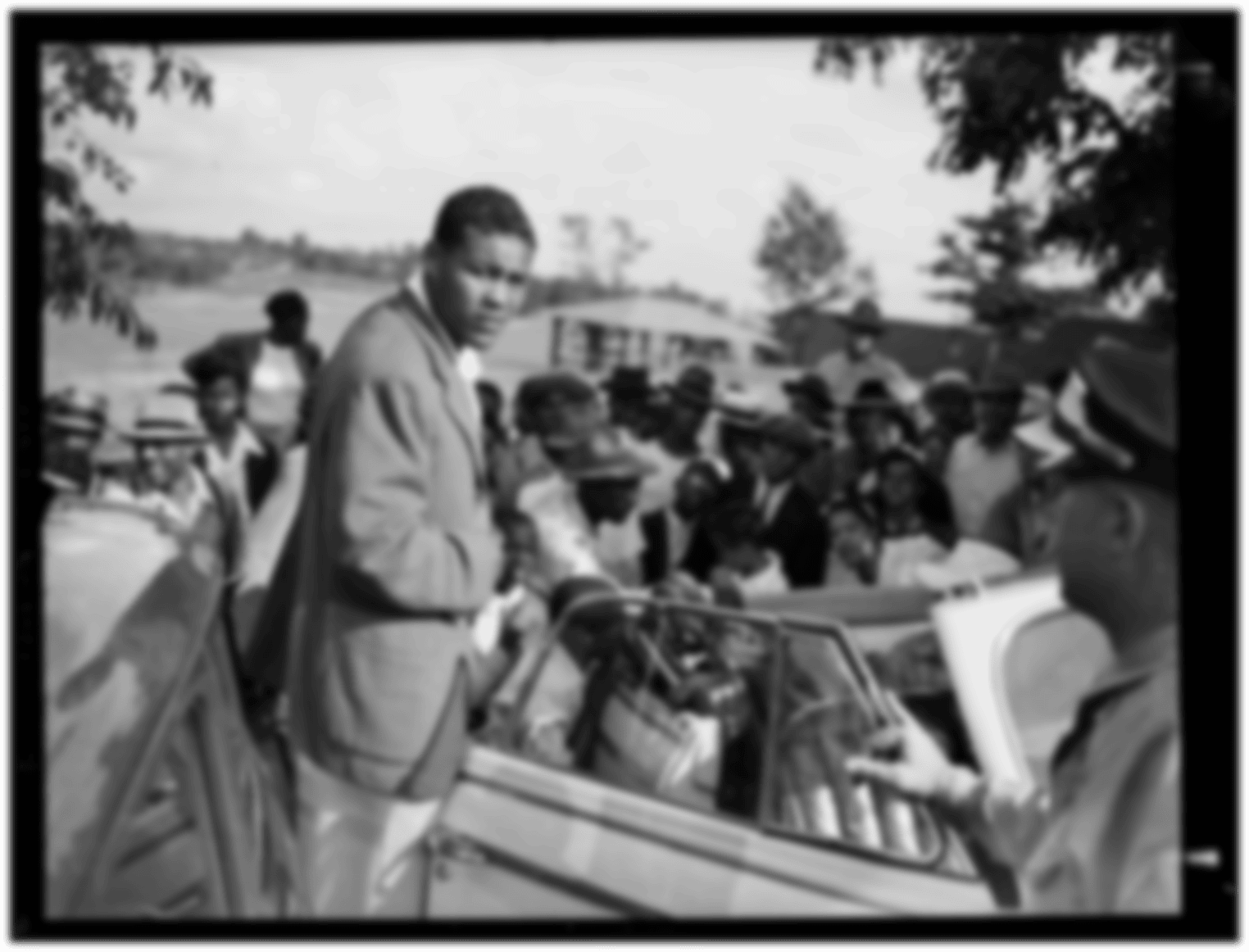 Boxer Joe Louis about to enter convertible at South Park golf course for Eastern Open Golf Association amateur tournament, Allegheny County, Pennsylvania, July 1941