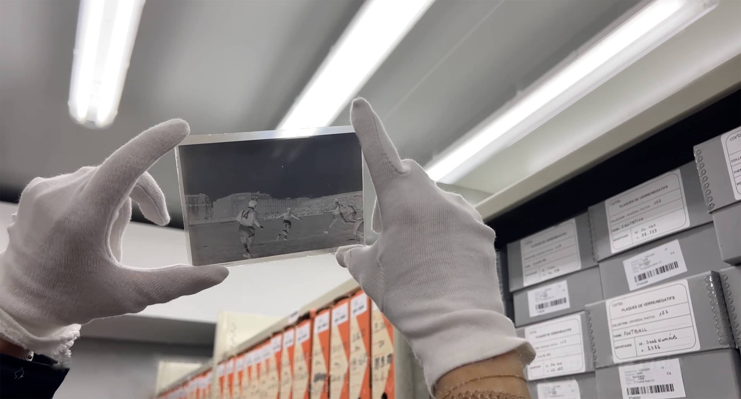 Person holding a glass plate of an image in the Sygma Archive, Garnay, France.