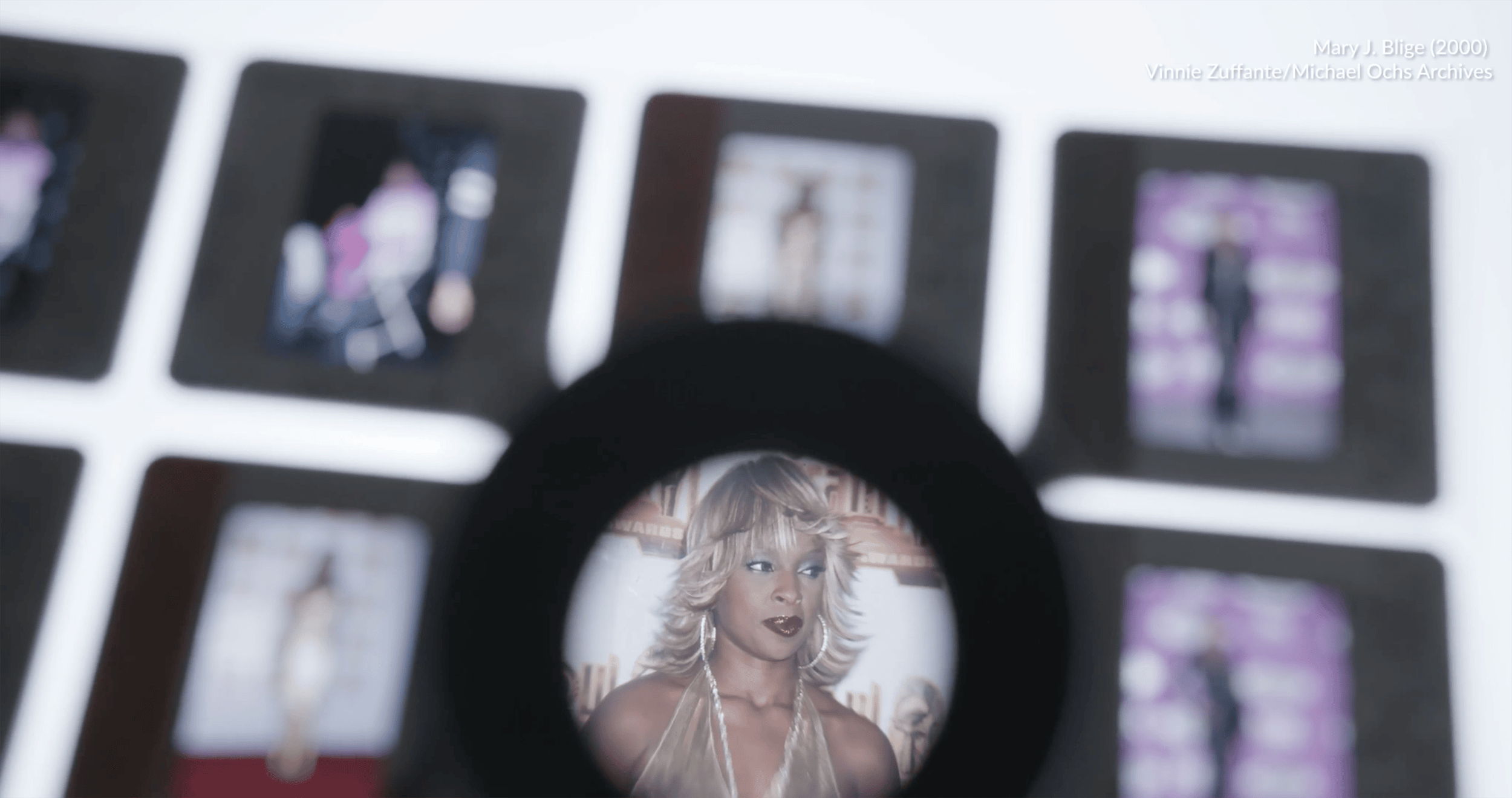 Image taken at the Getty Images Los Angeles Archive. A person with a loupe taking a closer look at negatives of Mary J. Blige